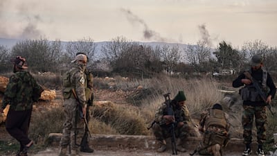 Syrian troops take position in the village of Hawsh Al Sayyid Ali, 2km from the Lebanon border, on Monday. AP