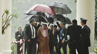 Saudi King Salman and Indonesian president Joko Widodo walk under umbrellas during heavy rain at the presidential palace in Bogor, West Java, Indonesia on March 1, 2017. King Salman arrived in the world's largest Muslim nation on Wednesday as a part of a multi-nation tour aimed at boosting economic ties with Asia. Achmad Ibrahim/AP Photo