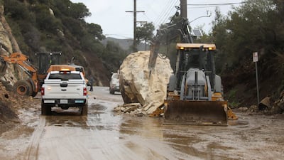 CalTrans workers chip away at a huge boulder that fell on Malibu Canyon Road in Malibu. Reuters