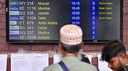 A passenger looks at a flight information board at the Hazrat Shahjalal International Airport in Dhaka, Bangladesh, on March 3, 2026 after carriers cancelled flights amid the Middle East conflict. AFP