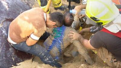 Rescuers work to free trapped labourers.