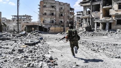 A member of the SDF runs for cover during heavy fighting in Raqqa, in October 2017. AFP