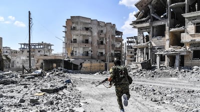 A member of the SDF runs for cover during heavy fighting in Raqqa, in October 2017. AFP