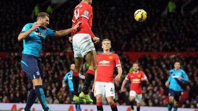Manchester United's Marouane Fellaini heads the ball down for the opening goal in United's 2-1 win over Stoke City on Tuesday in the Premier League. Peter Powell / EPA