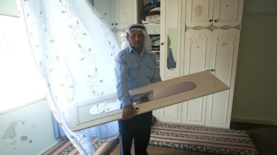 Palestinian Mohammed Mahmoud Ruziqat, 64, shows the broken mirror in one of the bedrooms in his home in the village of Tufa on the outskirts of Hebron, on June 19, 2014. Earlier this week, the Israeli army arrived at his son’s home, demanding for a place to sleep in. Heidi Levine / The National