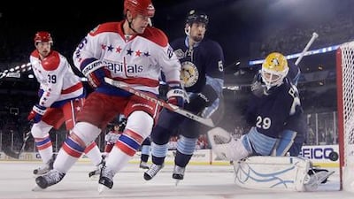 Matt Hendricks plays a shot for the Washington Capitals during the 2011 Winter Classic.