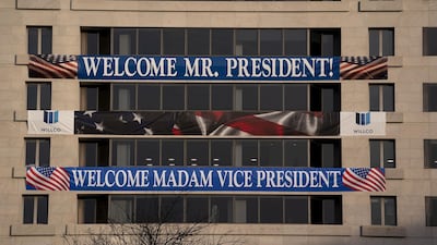A sign welcoming the new President and Vice President is displayed on a building near Freedom Plaza in Washington, DC. AFP