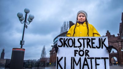 Swedish 15-year-old girl Greta Thunberg holds a placard reading "School strike for the climate" during a protest against climate change outside the Swedish parliament on November 30, 2018. AFP