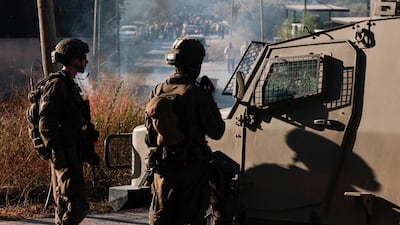 Members of the Israeli military stand guard near the scene of an alleged attack by settlers in the occupied West Bank. Reuters
