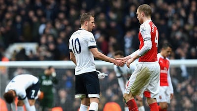 LONDON, ENGLAND - MARCH 05: Harry Kane of Tottenham Hotspur and Per Mertesacker of Arsenal shake hands after their 2-2 draw in the Barclays Premier League match between Tottenham Hotspur and Arsenal at White Hart Lane on March 5, 2016 in London, England. (Photo by Shaun Botterill/Getty Images)