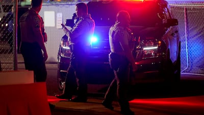 Police close off the entrance to the Maricopa County Recorders Office in Phoenix. AP
