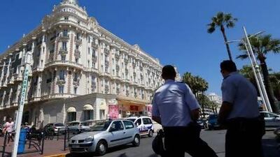French policemen keep watch outside the Carlton Hotel in Cannes after an armed man held up the jewellery exhibition "Extraordinary diamonds" of the Leviev diamond house in one of the biggest jewel thefts ever.
