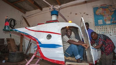 Malawian Felix Kambwiri sits in the cockpit of the helicopter he built out of scrap metal and fibreglass in his garage on February 19, 2016. Amos Gumulira/AFP