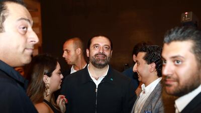 Lebanese Prime Minister Saad Hariri greets supporters in his house in downtown Beirut while awaiting the results of an election in which his Future Movement party lost a third of its seats. Anwar Amro / AFP