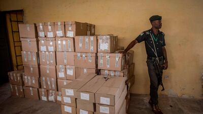 A Nigerian police officer monitors boxes of ballots on February 16, 2019, after presidential and parliamentary elections were suddenly postponed. AFP