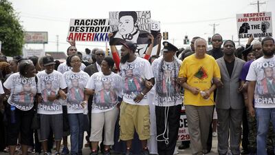 Michael Brown Sr, center, leads a march in remembrance of his son, Michael Brown, on August 9, in Ferguson, Mo. Jeff Roberson/AP