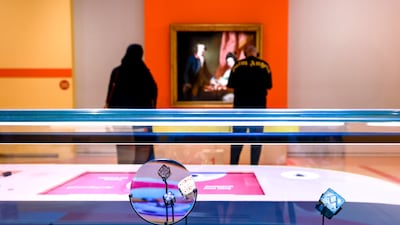 Ancient six-sided dice displayed alongside Francis Cotes's Portrait of William and Penelope Welby Playing Chess (1769) at Louvre Abu Dhabi's A Board Game Adventure. Victor Besa / The National