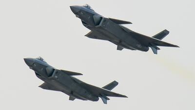 FILE - In this Nov. 1, 2016, file photo, a pair of J-20 stealth fighter jets fly at the China's International Aviation and Aerospace Exhibition in Zhuhai, China's Guangdong province. China’s homebuilt J-20 stealth fighter has conducted sea training for the first time, the air force said Wednesday, May 9, 2018. (Chinatopix via AP, File)