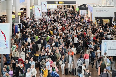 People walk by a departures board after a cyber attack caused delays at Brussels International Airport in Zaventem, Belgium, on Saturday, September 20, 2025. AP.