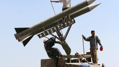 Hezbollah supporters fix the party's flag on top of their rocket models in Bourj Qalawi near the southern port city of Tyre, Lebanon, 2007. AP Photo
