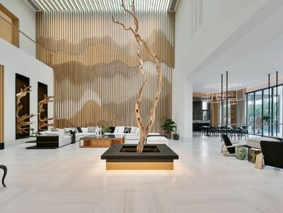 A timber Tree of Life=inspired sculpture in the double-height central hub of the property.