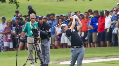 Jon Rahm of Spain hits his approach shot on the seventh hole. Tannen Maury / EPA