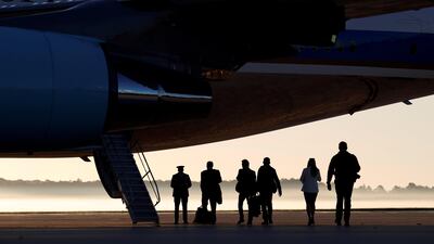 On a misty morning, members of the White House press corps board Air Force One at Joint Base Andrews in Maryland, US, on their way to Las Vegas with US President Donald Trump. Kevin Lamarque / Reuters