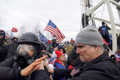 Alan William Byerly, right, is seen allegedly attacking an Associated Press photographer during a riot at the US Capitol in Washington. AP
