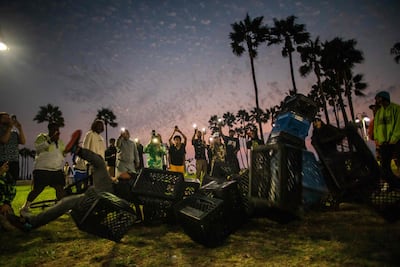 A man falls from a collapsed pyramid of milk crates while he participates of the Milk Crate Challenge. AFP