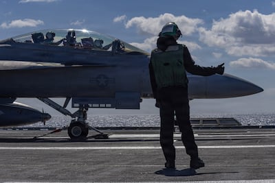 US Navy sailor signals for the launch of an F/A-18F Super Hornet aircraft from the USS Gerald R Ford. US Navy / Handout via Reuters
