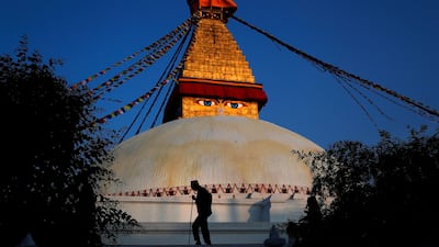 A Nepalese elderly man walks past Boudhanath Stupa in Kathmandu, Nepal. The ancient Stupa, which is one of the largest in the world is an important pilgrimage site for the Buddhists and a UNESCO World Heritage too. AP