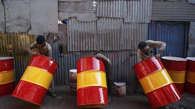 Workers paint recycled drums on February 11, 2014, at a workshop in Dharavi, Mumbai, India, one of Asia’s largest slums. Danish Siddiqul / Reuters