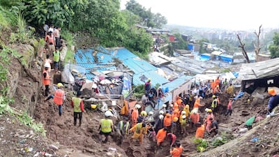 Rescue workers search for survivors after a landslide caused by heavy rain in Mumbai. EPA