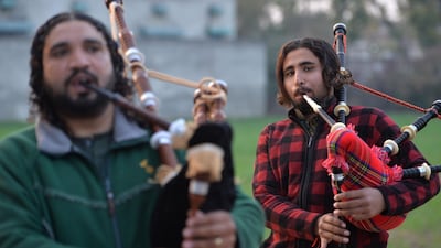 A Pakistani musical band perform with bagpipes made at the Mid East bagpipe factory in the eastern city of Sialkot. AFP.