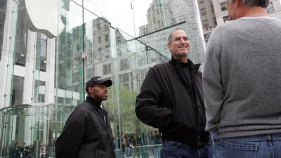 File Photo - Apple Chief Executive Steve Jobs looks at the crowds at the grand opening of the new Apple Store on 5th Avenue in New York in this May 19, 2006. Apple Inc co-founder and former CEO Jobs died on October 5, 2011 REUTERS/Seth Wenig