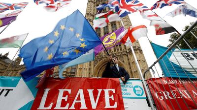 An anti-Brexit protester waves an EU flag outside the Houses of Parliament in London, Britain. Reuters