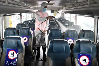 A worker sanitises a Dubai school bus. Wam