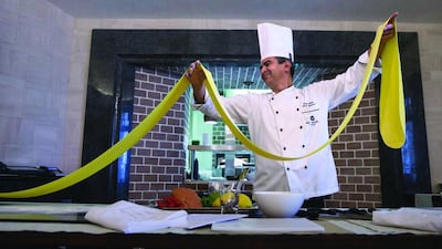 Stefano Viola, the head Italian chef at the Villa Toscana restaurant at the St Regis Abu Dhabi on the Corniche, demonstrates pasta preparation, which he teaches during his regular cooking classes at the hotel. Silvia Razgova / The National