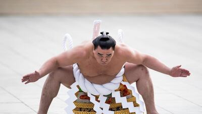 Mongolian-born sumo grand champion or “yokozuna” Harumafuji performs a ring-entering ceremony at Meiji Shrine in Tokyo on January 6, 2017. Three sumo grand champions – Hakuho, Kakuryu and Harumafuji – made their New Year pilgrimage at the shrine. Behrouz Mehri / Agence France-Presse