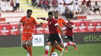 Luis Jimenez, the Al Ahli midfielder, centre, opened the scoring for the hosts before Ajman staed a second-half fightback to win the Etisalat Cup Group C match 2-1 last night. Lee Hoagland / The National