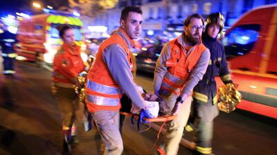 A woman is evacuated from the Bataclan concert hall after the shooting in Paris, in November 2015. AP Photo