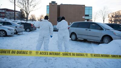 Investigators search the parking lot at the Islamic Cultural Centre in Quebec City, Canada on January 30, 2017. Gunmen stormed into a Quebec mosque during evening prayers on January 29 and opened fire on dozens of worshippers, killing six and wounding eight. Alice Chiche / AFP