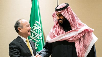 Masayoshi Son, chairman and chief executive of SoftBank Group shakes hands with Crown Prince Mohammed bin Salman in New York after signing an agreement for the huge solar project. Jeenah Moon / Bloomberg