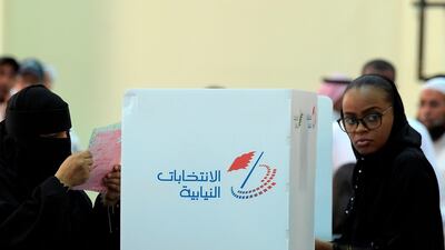Two women cast their ballots at a polling station in Bahrain. AFP
