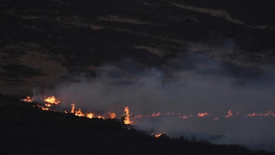 Firefighters tackle a blaze on moorland above Marsden. AFP