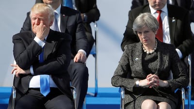 US President Donald Trump and Britain's Prime Minister Theresa May during a ceremony at the NATO headquarters before the start of a summit in Brussels last year. REUTERS/Christian Hartmann/File Photo