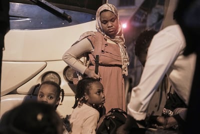 A sudanese woman and children, who were driven from their homes and are now returning, wait at a bus station in Cairo, Egypt, Friday, April 25, 2025. (AP Photo / Amr Nabil)