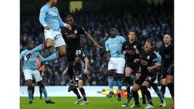 Joleon Lescott heads home for Manchester City against Aston Villa. The defender is confident his team can fight for the title.
