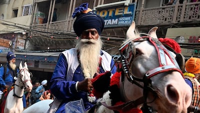 A Nihang, Sikh man who belongs to the armed Sikh order, rides his horse as he participates in "Nagar Kirtan" (religious procession) on the eve of the 550th birth anniversary of Sikhism founder Guru Nanak Dev in New Delhi. AFP
