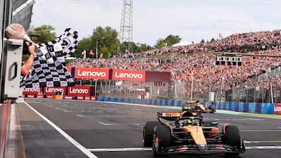 McLaren driver Lando Norris crosses the finish line to win the Hungarian Grand Prix ahead of teammate Oscar Piastri. EPA